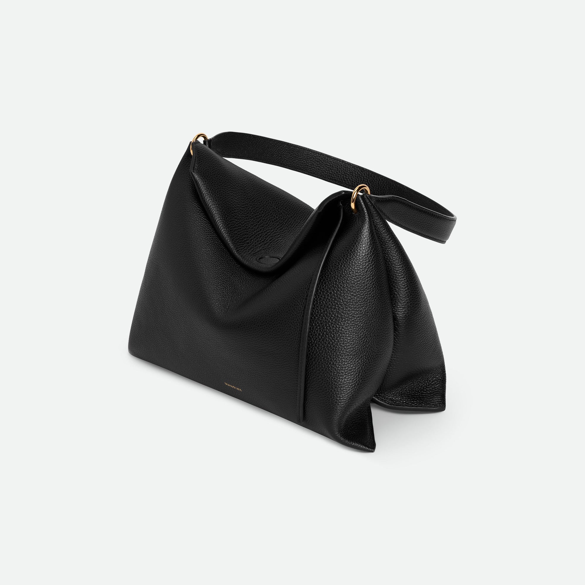 Wandler Penelope Tote Small in the color Black Crust made from calf leather with golden hardware and soft slouchy silhouette, pictured from above, three quarters view.