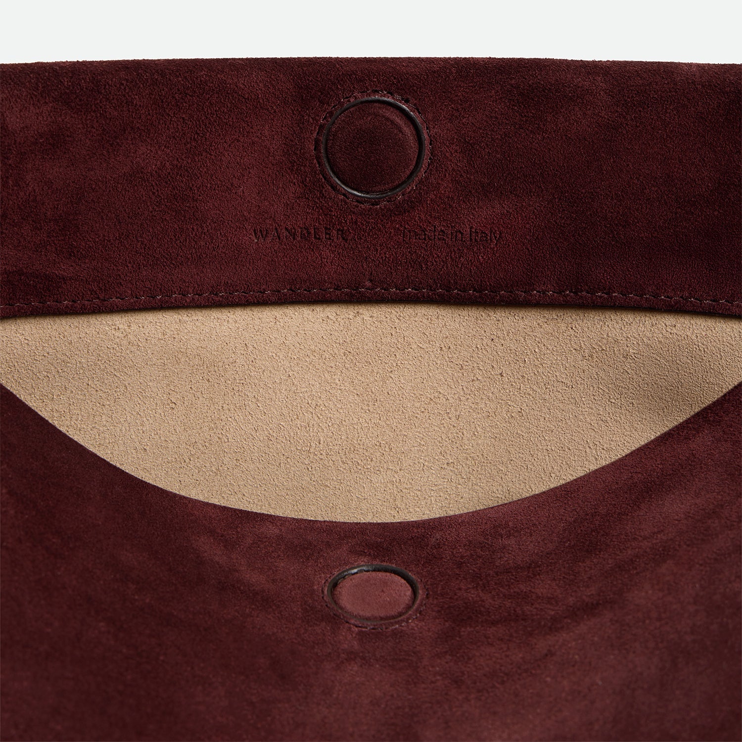 Wandler Penelope Tote Small in the color Acai Suede / Black made from calf leather with golden hardware and soft slouchy silhouette, close up detailing the closure and leather.