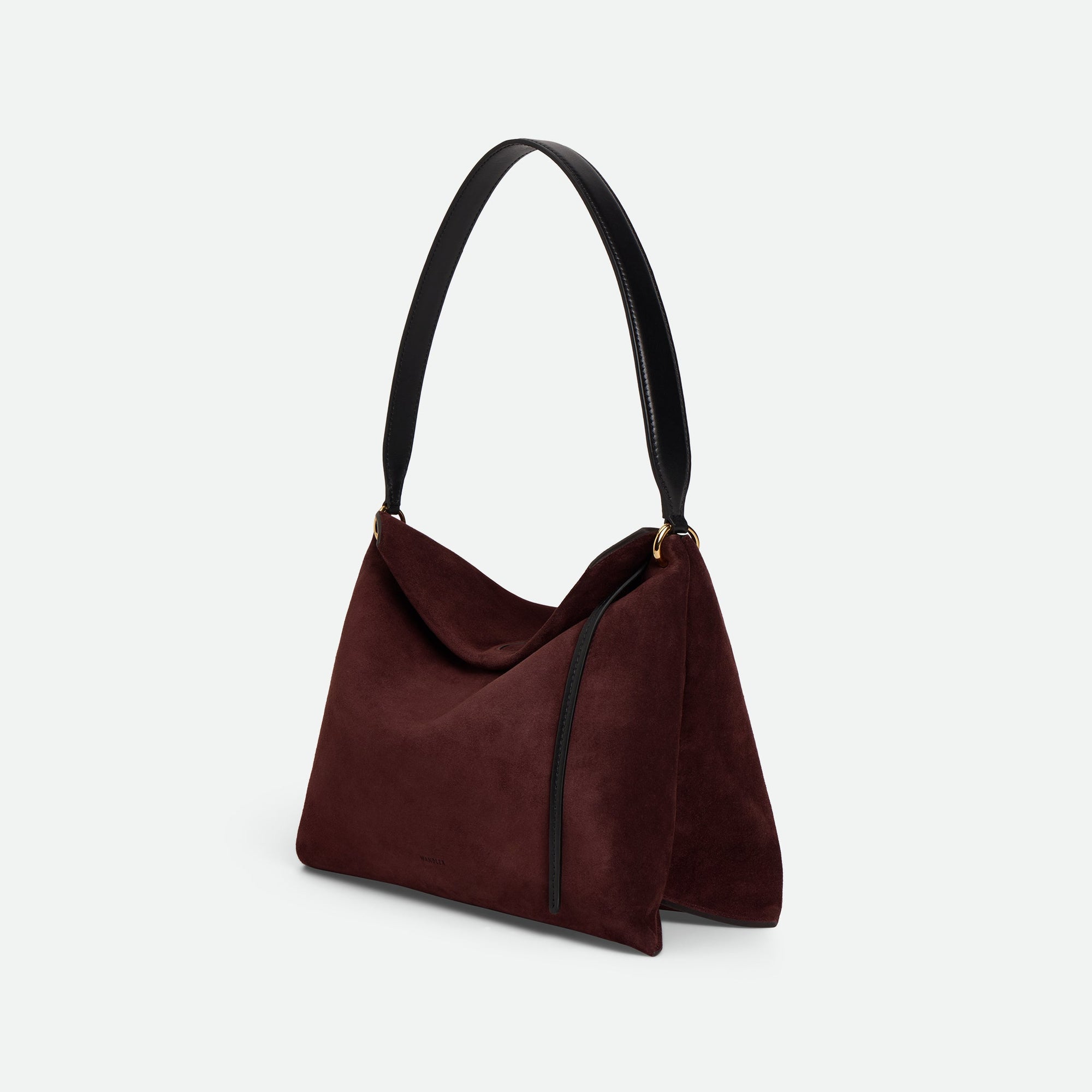 Wandler Penelope Tote Small in the color Acai Suede / Black made from calf leather with golden hardware and soft slouchy silhouette, three quarters view with the straps suspended into the air.