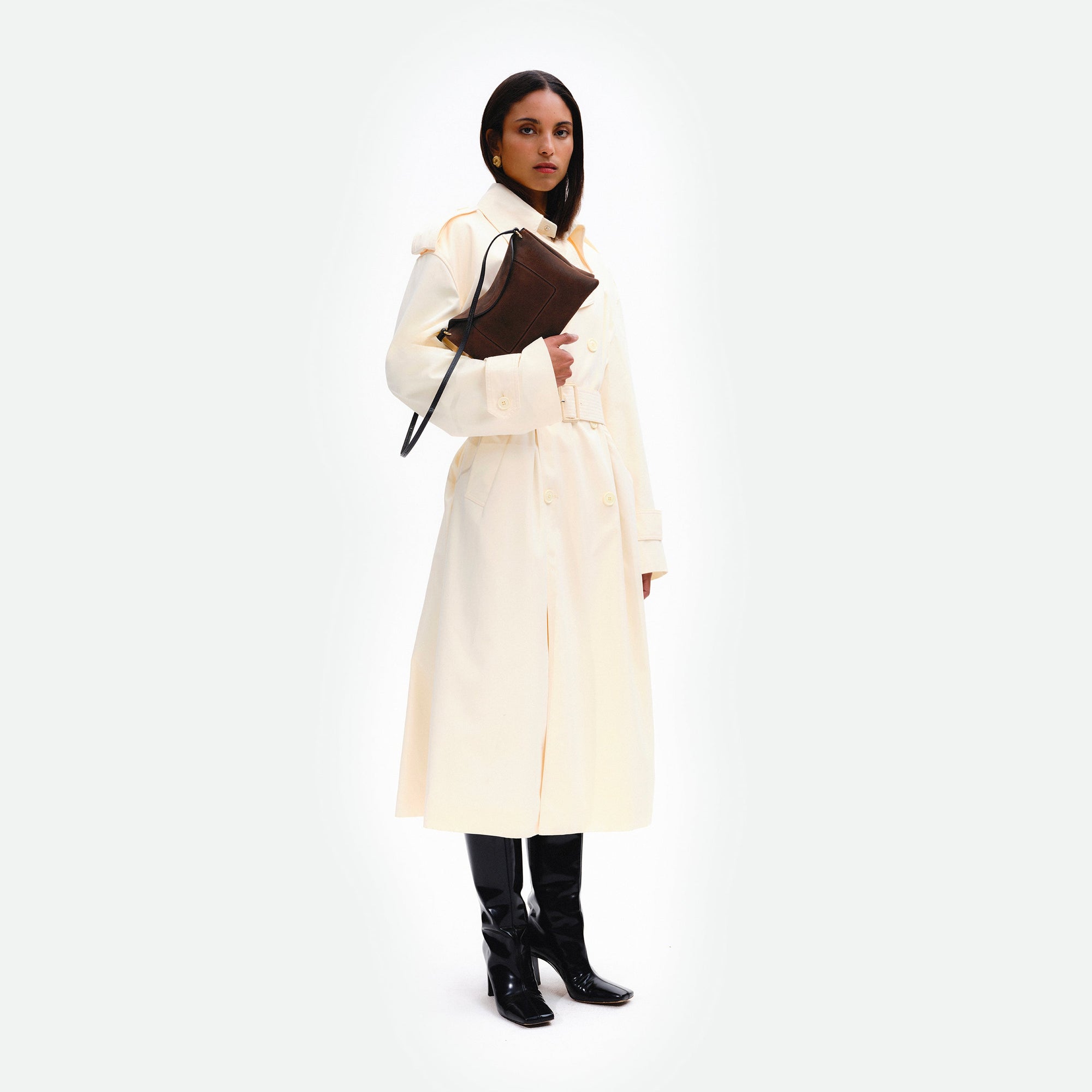 Wandler Penelope Slouch Bag in the color Palissander Suede, made from calf leather with golden hardware and adjustable slim strap, pictured being held in the hand by model.