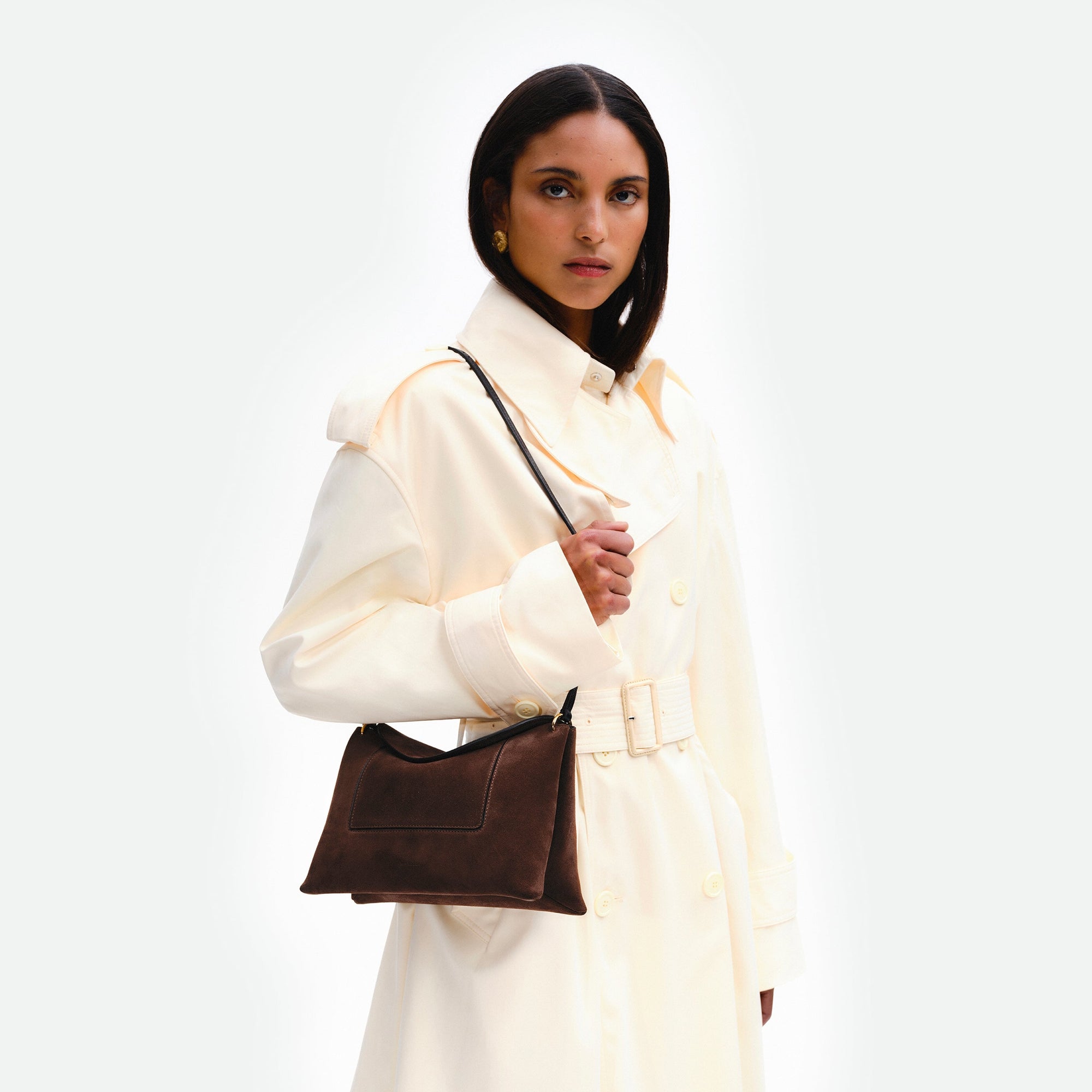 Wandler Penelope Slouch Bag in the color Palissander Suede, made from calf leather with golden hardware and adjustable slim strap, pictured being worn on the shoulder by model.
