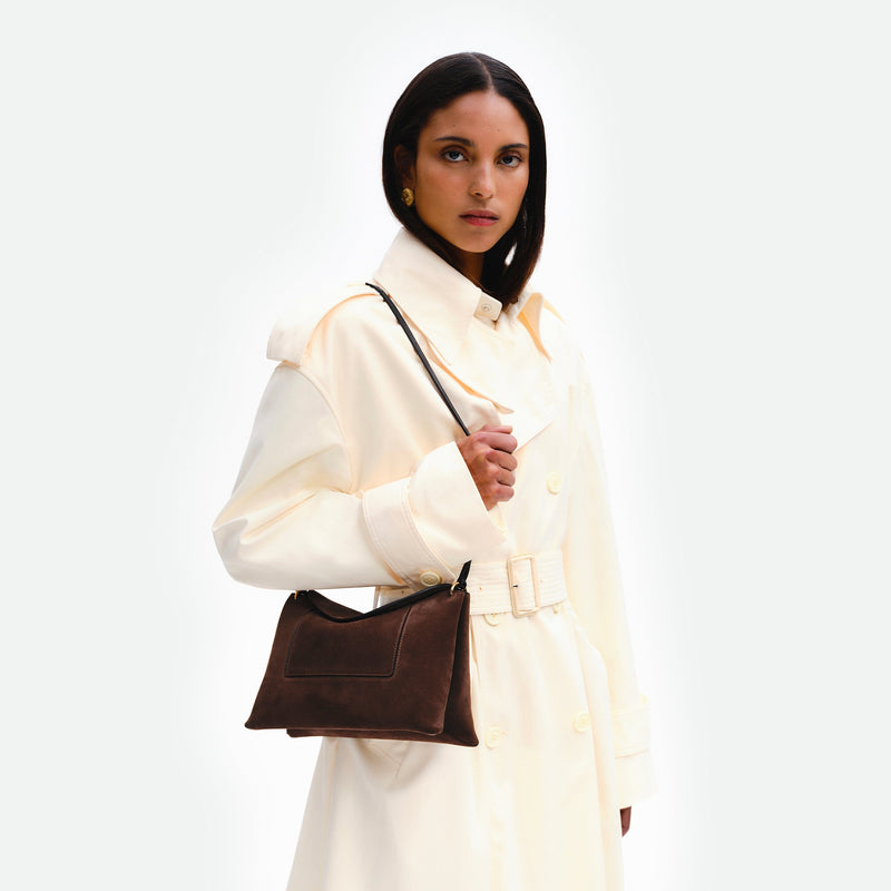 Wandler Penelope Slouch Bag in the color Palissander Suede, made from calf leather with golden hardware and adjustable slim strap, pictured being worn on the shoulder by model.